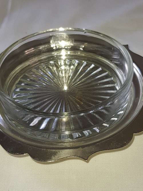 A VINTAGE BUTTER DISH EPNS WITH A CRYSTAL BOWL AND A LID SOLD AS IS