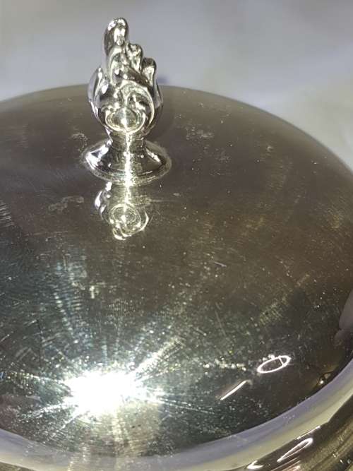 A VINTAGE BUTTER DISH EPNS WITH A CRYSTAL BOWL AND A LID SOLD AS IS