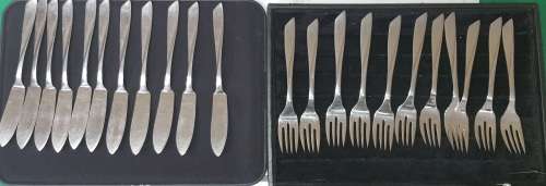 A VINTAGE SET OF FISH KNIVES AND FORKS MADE BY KRIIUS SOLINGEN SOLD AS IS