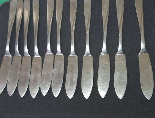 A VINTAGE SET OF FISH KNIVES AND FORKS MADE BY KRIIUS SOLINGEN SOLD AS IS