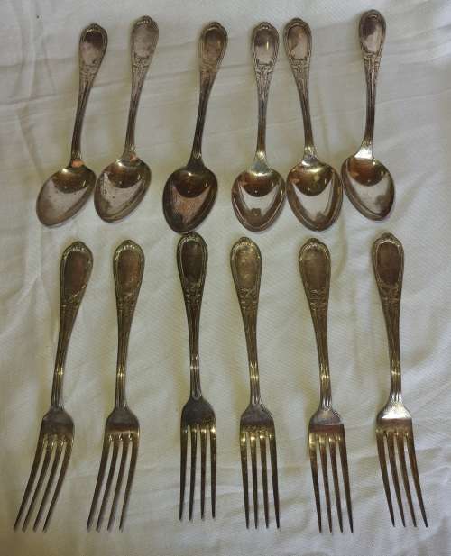 A SET OF VINTAGE SPOONS AND FORKS STAMPED GERP K 100 SOLD AS IS