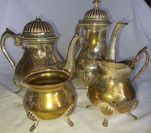 A VINTAGE EPNS ORNATE TEA SET SOLD AS IS