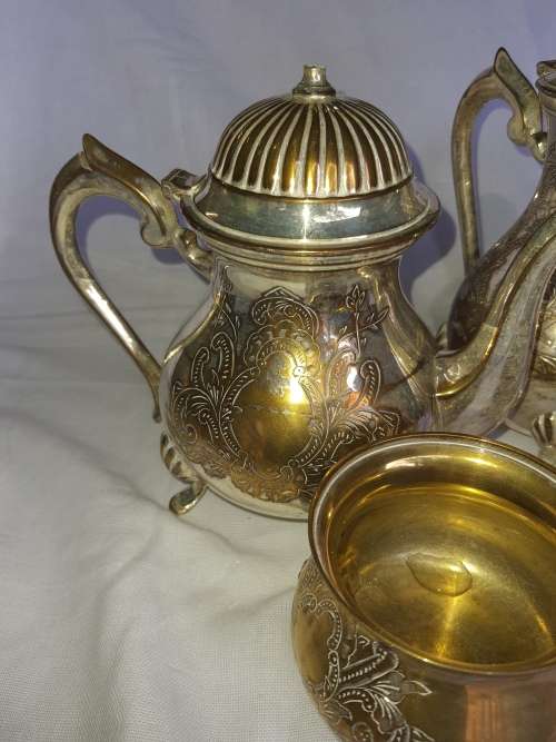 A VINTAGE EPNS ORNATE TEA SET SOLD AS IS