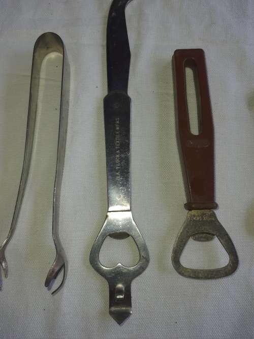 A VINTAGE COLLECTION OF BOTTLE OPENERS