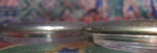 A vintage set of 6 cut glass coasters with silver plated brims sold as is