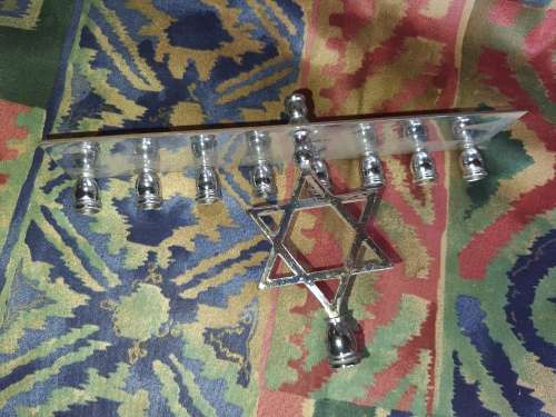 A BEAUTIFUL SILVER PLATED MINORAH SOLD AS IS
