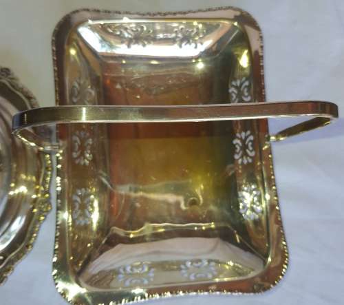 TWO VINTAGE SILVER PLATED ITEMS A BUTTER BOWL WITH A LID AND A SERVING BASKET SOLD AS IS
