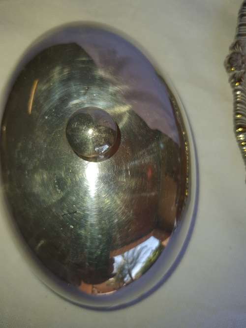 TWO VINTAGE SILVER PLATED ITEMS A BUTTER BOWL WITH A LID AND A SERVING BASKET SOLD AS IS