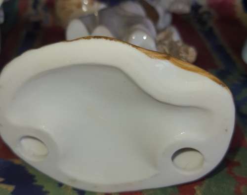 A COLLECTION OF VINTAGE PORCELAIN FIGURINES IN MINT CONDITION SOLD AS IS