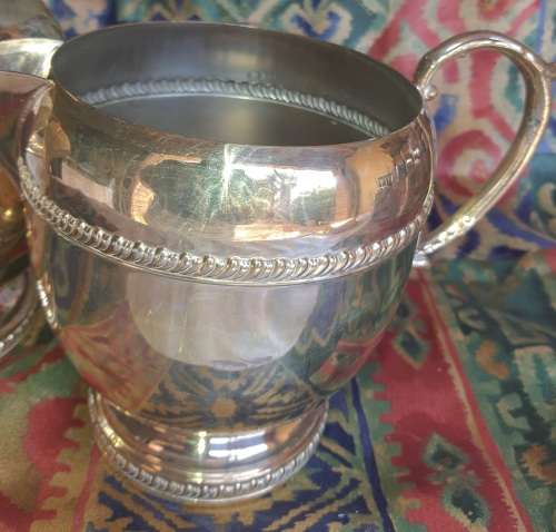 A SET OF TWO VINTAGE SILVER PLATED ROMAN STYLE JUGS