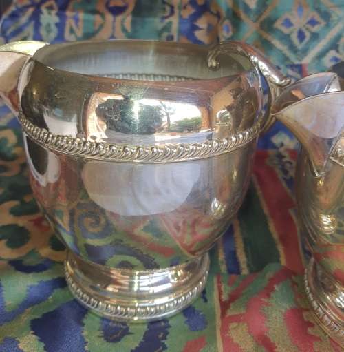 A SET OF TWO VINTAGE SILVER PLATED ROMAN STYLE JUGS