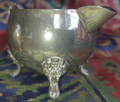 A VINTAGE PAIR OF SILVERPLATED UTENSILS , A CREAMER AND A SUGAR BOWL