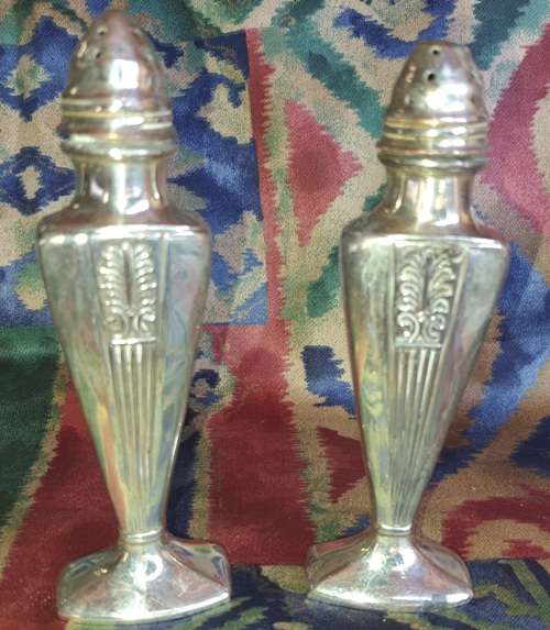 A SET OF ANTIQUE SALT AND PEPPER DISPENSORS STAMPED EP ON LEAD E.16 SOLD AS IS