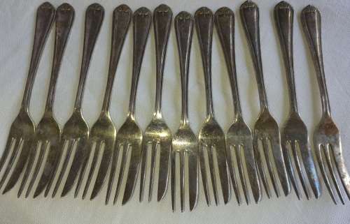 A vintage set of 12 desert forks Sold as is