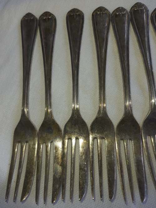 A vintage set of 12 desert forks Sold as is