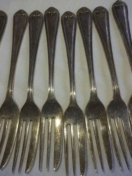 A vintage set of 12 desert forks Sold as is