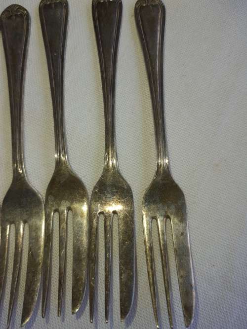 A vintage set of 12 desert forks Sold as is
