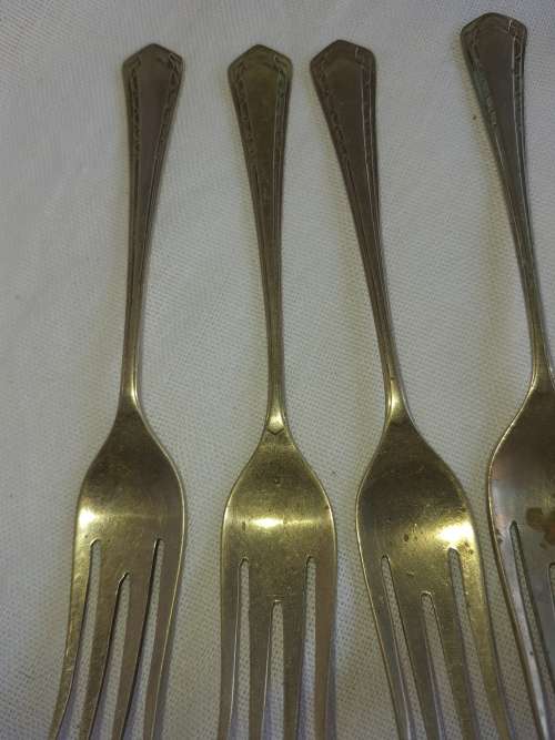 A DOZEN ANTIQUE DESERT FORKS SOLD AS IS