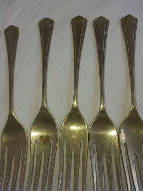 A DOZEN ANTIQUE DESERT FORKS SOLD AS IS