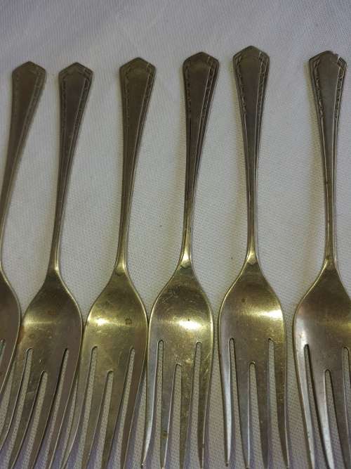 A DOZEN ANTIQUE DESERT FORKS SOLD AS IS