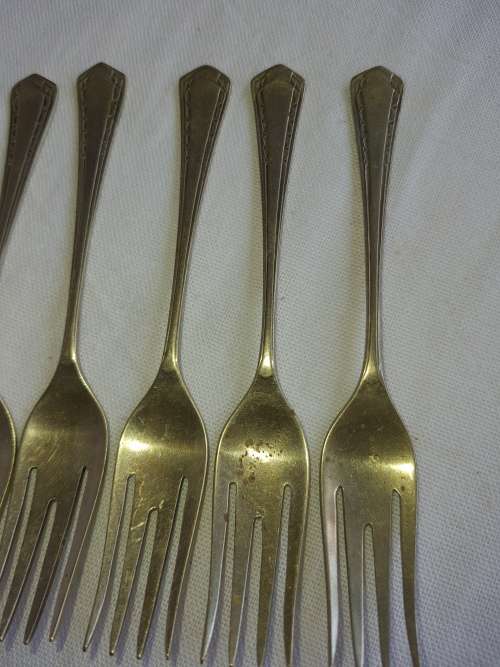 A DOZEN ANTIQUE DESERT FORKS SOLD AS IS