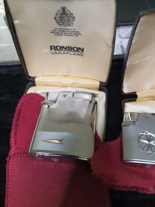 AN ANTIQUE COLLECTION SMOKER COLLECTORS ITEMS RARE LIGHTERS AND A PIPE SOLD AS IS