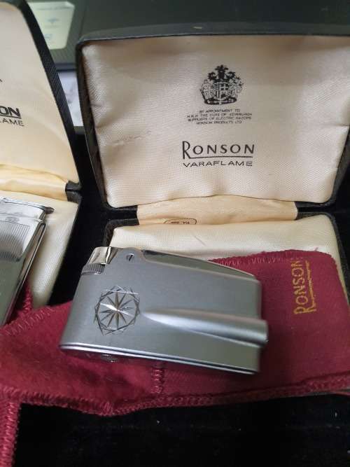 AN ANTIQUE COLLECTION SMOKER COLLECTORS ITEMS RARE LIGHTERS AND A PIPE SOLD AS IS