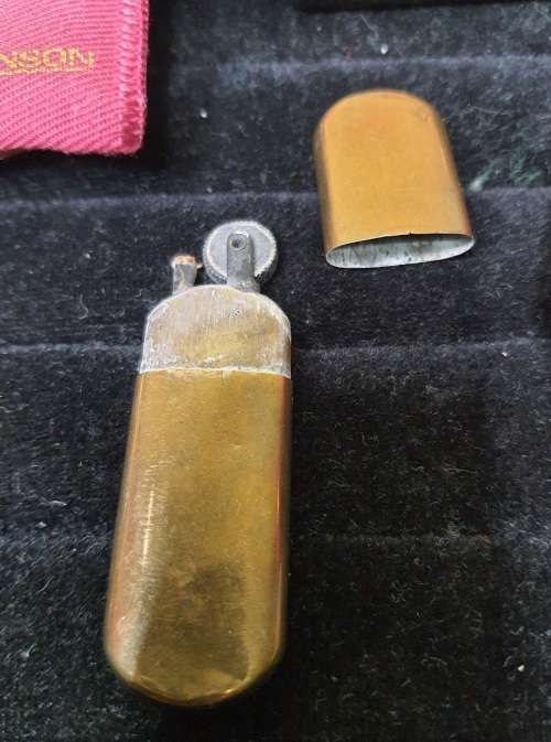 AN ANTIQUE COLLECTION SMOKER COLLECTORS ITEMS RARE LIGHTERS AND A PIPE SOLD AS IS