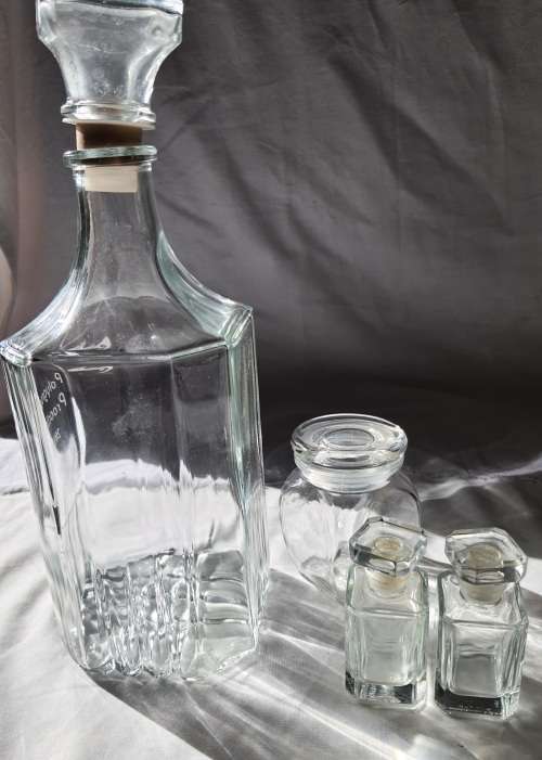 A COLLECTION OF VINTAGE STORAGE BOTTLES SOLD AS IS