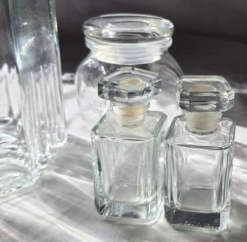 A COLLECTION OF VINTAGE STORAGE BOTTLES SOLD AS IS
