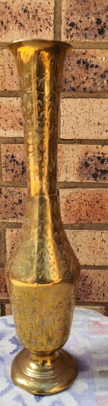 A VINTAGE FLUTED VASE MADE OF BRASS SOLD AS IS