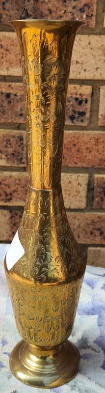 A VINTAGE FLUTED VASE MADE OF BRASS SOLD AS IS