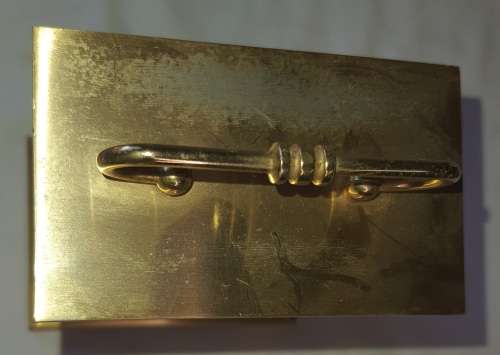 A BRONZE RYTHM TRANSSISTER ALARM CLOCK SOLD AS IS