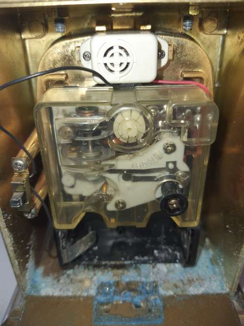 A BRONZE RYTHM TRANSSISTER ALARM CLOCK SOLD AS IS
