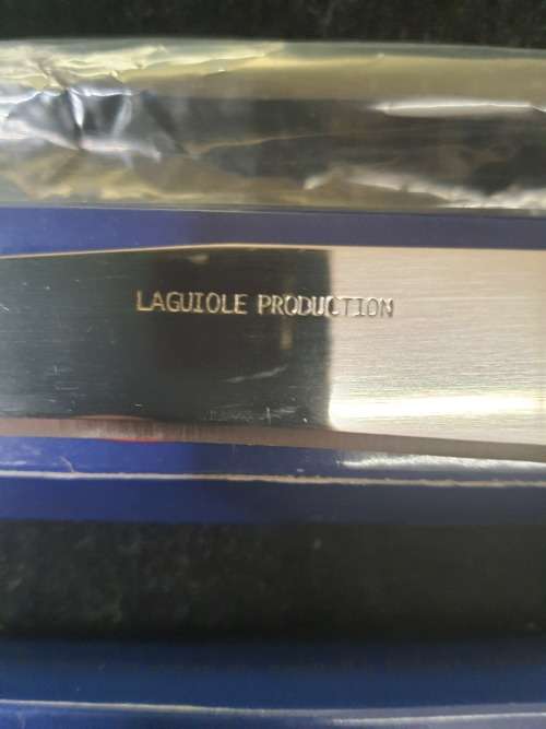 TWO VINTAGE FRENCH LAGUIOLE PRODUCTION CUTTLERY CARVING KNIVE AND A TABLE SPOON SOLD AS IS