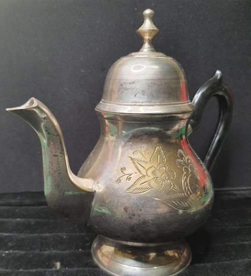 AN ANTIQUE SILVER PLATED TEA POT JUG SOLD AS IS
