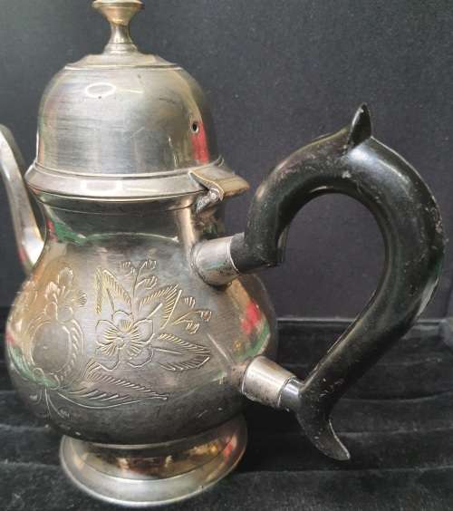 AN ANTIQUE SILVER PLATED TEA POT JUG SOLD AS IS