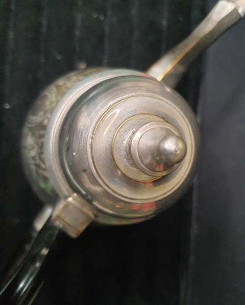 AN ANTIQUE SILVER PLATED TEA POT JUG SOLD AS IS
