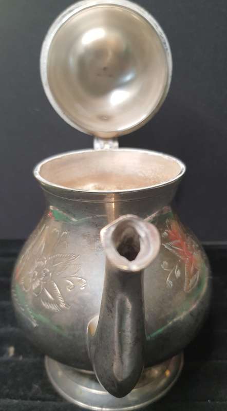 AN ANTIQUE SILVER PLATED TEA POT JUG SOLD AS IS