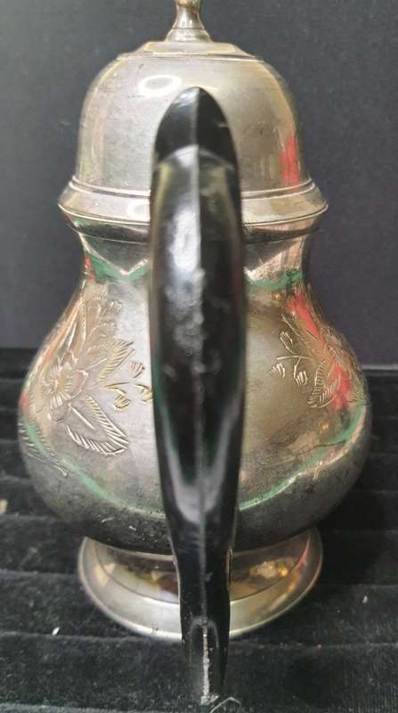 AN ANTIQUE SILVER PLATED TEA POT JUG SOLD AS IS