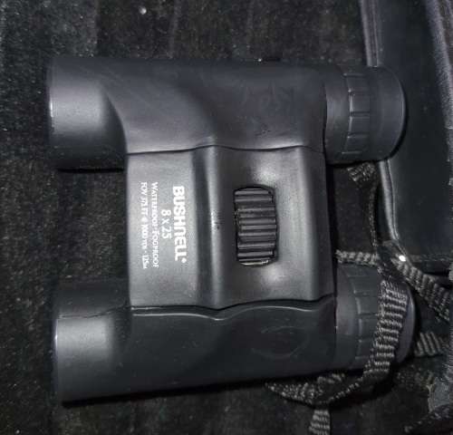 A BUSHNELL POCKET BINOCUARS SOLD AS IS
