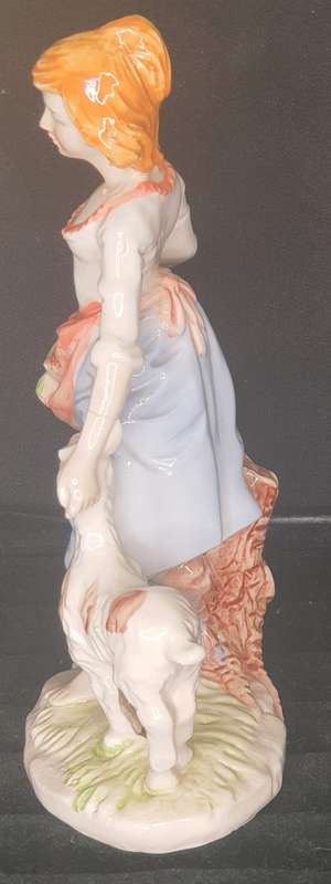 A FARM GIRL WITH HER DOG CARRYING FLOWER PORCELAIN FIGURINE SOLD AS IS