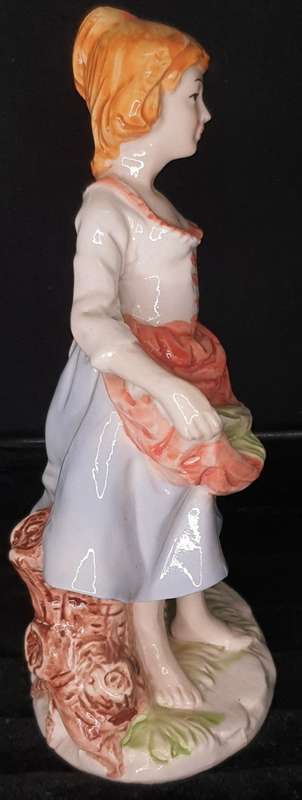A FARM GIRL WITH HER DOG CARRYING FLOWER PORCELAIN FIGURINE SOLD AS IS