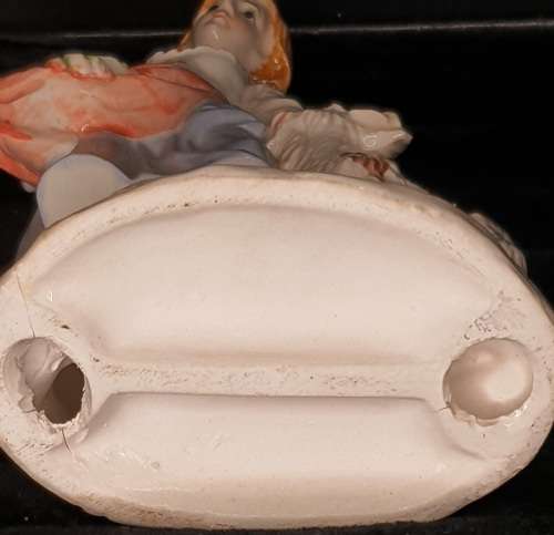 A FARM GIRL WITH HER DOG CARRYING FLOWER PORCELAIN FIGURINE SOLD AS IS