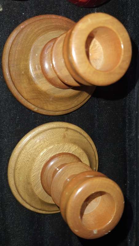 A GENUINE SET OF TWO PJ VAN RHEENEN STINK WOOD CANDLE STANDS AND A SET OF SIX MULTI COLOURED NAPKIN