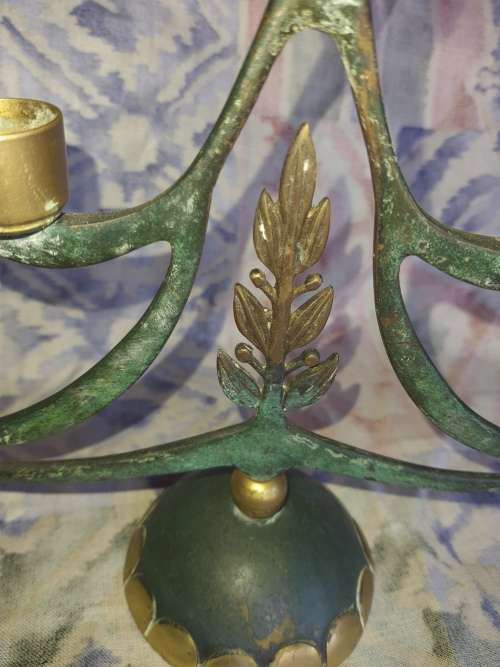 A BEAUTIFUL WRATH IRON AND BRASS MINORA IN GOOD CONDITION SOLD AS IS
