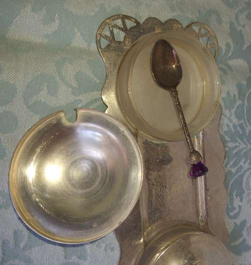 A SILVER PLATED WITH GLASS BOWLS AND A SPOON CONDOMENTS SET