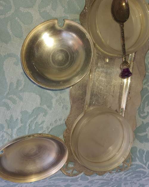 A SILVER PLATED WITH GLASS BOWLS AND A SPOON CONDOMENTS SET