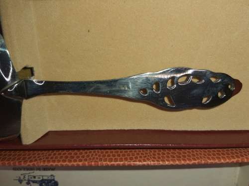 A RARE SILVER NICKLE PLATED CAKE CUTTER MADE IN HOLLAND SOLD AS IS