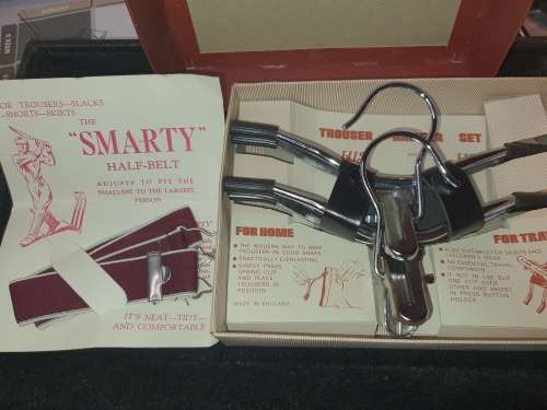 A VINTAGE TRAVELERS TROUSER HANGER IN ITS ORIGINAL BOX SOLD AS IS